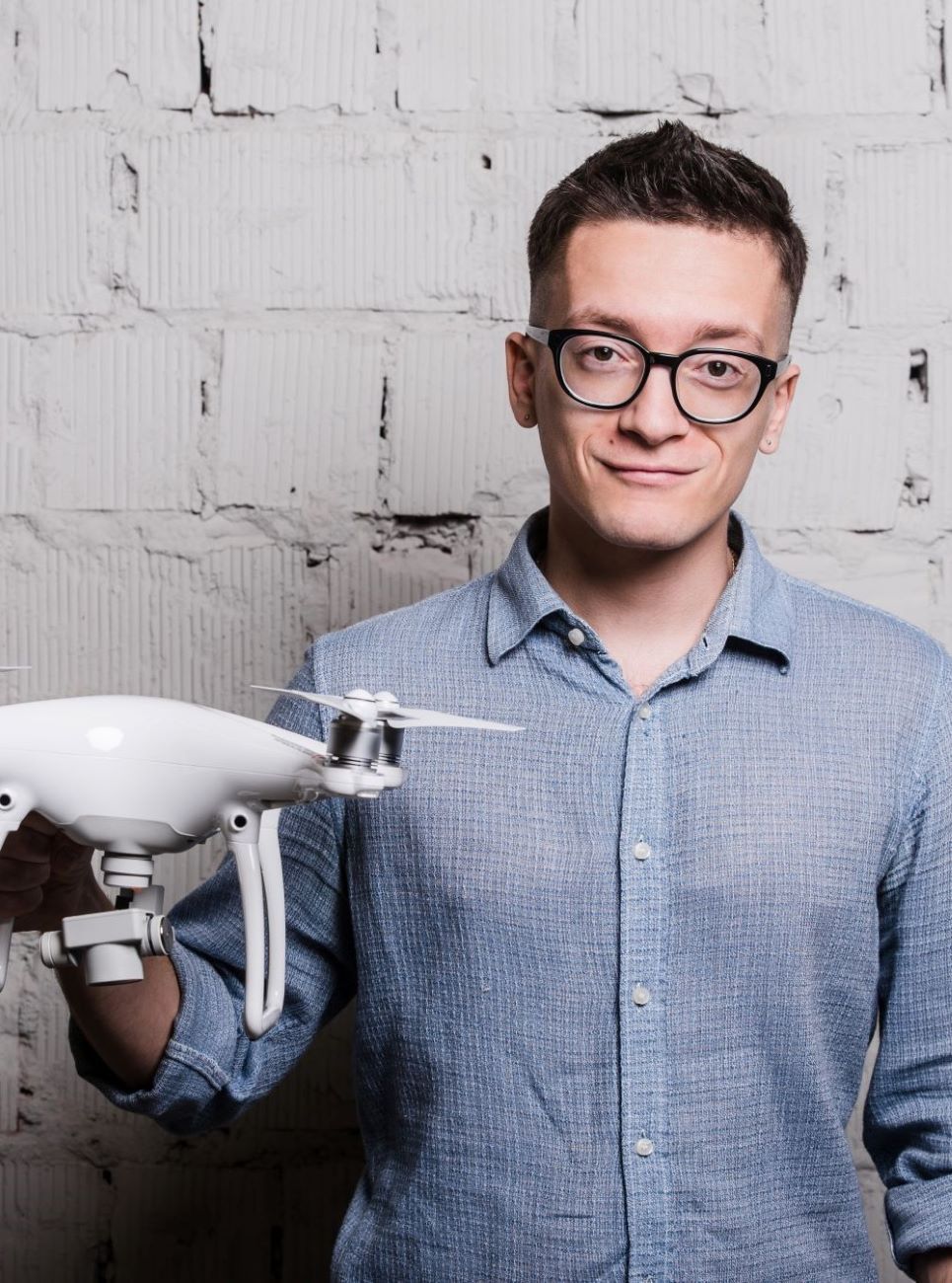 young-stylish-man-in-glasses-with-quadcopter-drone-2023-11-27-05-18-14-utc-1.jpg